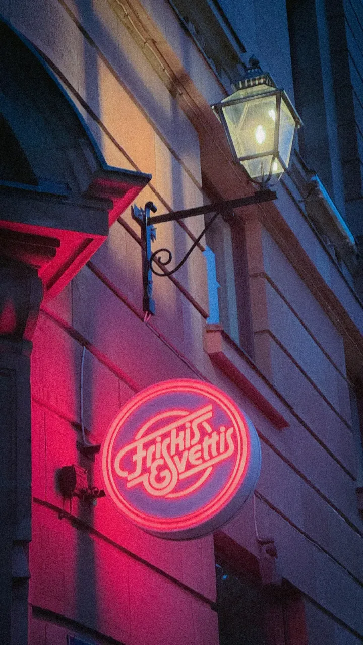 Neon cafe sign and a street lamp in Gothenburg